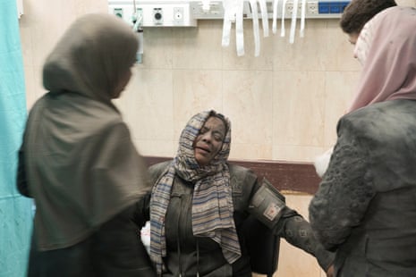 People wounded in the Israeli bombardment wait for treatment in a hospital in Deir al-Balah