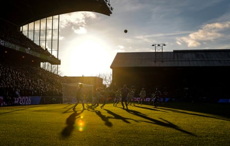 A view of the Holmesdale End of the ground as Crystal Palace attack and the sun sets.