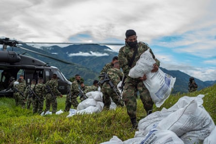Colombian soldiers offload humanitarian aid from a UN helicopter for displaced people in Ituango on 27 July.