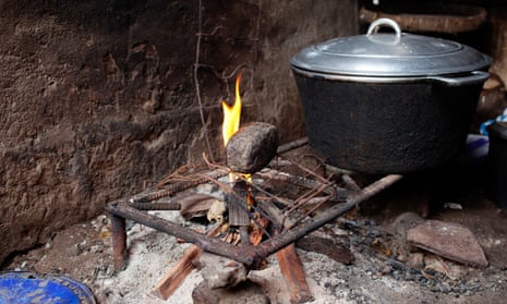 Stone used for breast-ironing is placed on a fire.