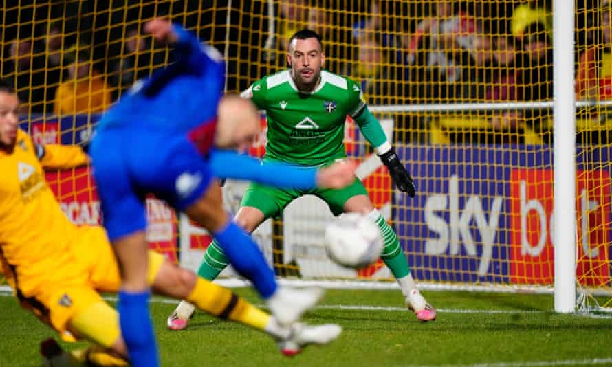 Dean Bouzanis prepares to make a save for Sutton against Harrogate