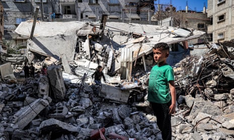 A boy stands by the rubble of a collapsed building in Rafah in the southern Gaza Strip on 9 April.