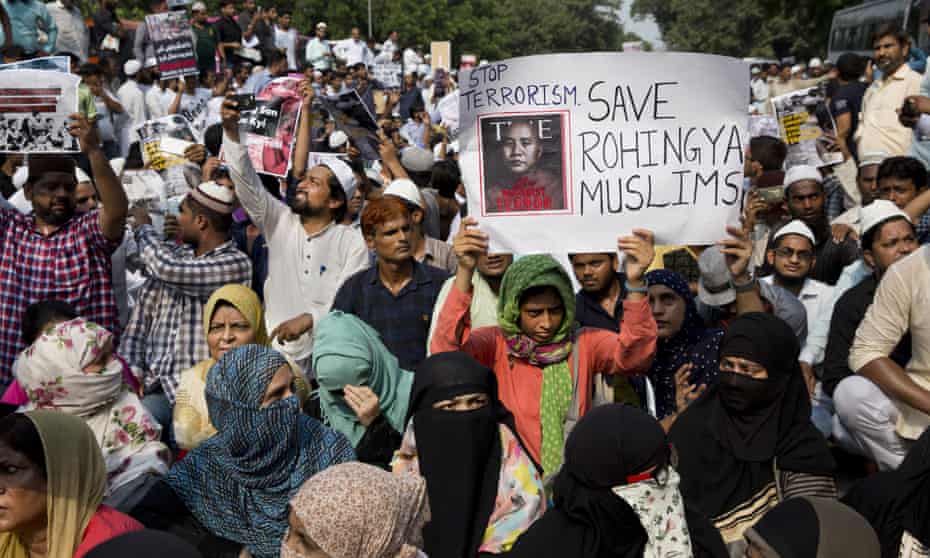 Indian Muslims hold placards and shout slogans during a protest against the persecution of Rohingya Muslims