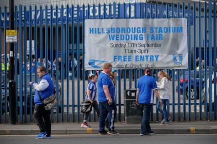Home fans arrive past a sign advertising the event last Sunday a wedding fair before the Sheffield Wednesday v Sheffield United EFL Championship match.