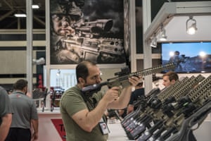 A convention attendee tries out a gun