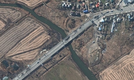 Destroyed vehicles and bridge damage shown in satellite image of Irpin, northwest of Kyiv, Ukraine.