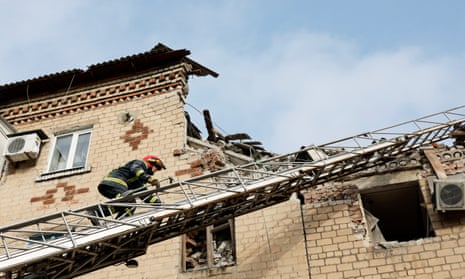 A rescue worker at the site of residential houses heavily damaged by a Russian missile strike in the town of Selydove