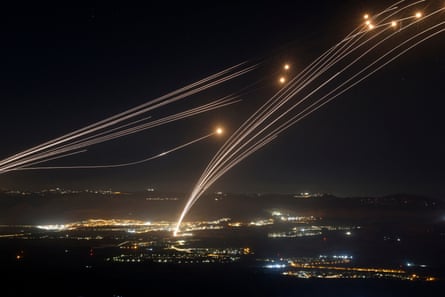 Hezbollah rockets fired from southern Lebanon are intercepted by the Iron Dome defence system over northern Israel during cross-border clashes in August 2024.