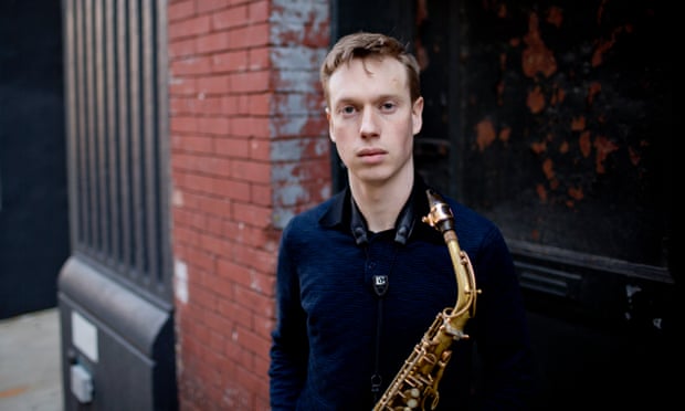 sam braysher holding an alto saxophone