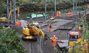 Workers repair the section of track where the tram crashed in Croydon.