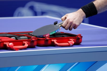 A France team member retrieves his bat after it was checked for legality