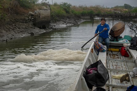 A man on a boat in foamy water