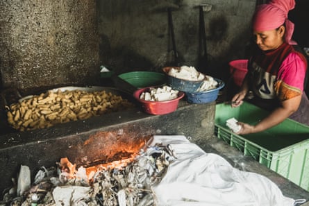 A worker tends to a tofu fryer fuelled by plastic scraps at a factory in Tropodo, Indonesia.