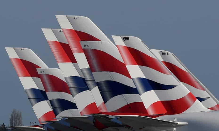 Tailfins of British Airways planes parked at Heathrow airport.