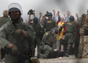US border patrol agents make arrests during a pro-migration protest by members of faith groups in support of Central American asylum-seekers in Tijuana, Mexico.