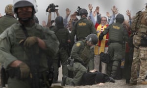 US Border Patrol agents arrest people during a multi-faith pro-migration protest on the US-Mexico border in San Diego.