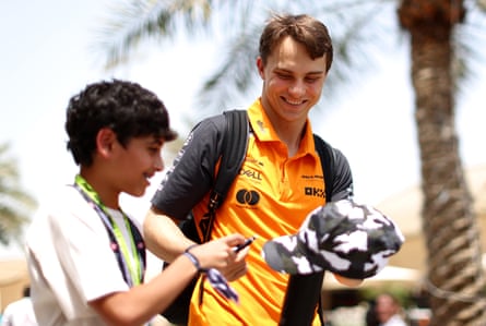 Oscar Piastri signs a cap for a fan in Bahrain