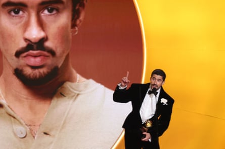 The Puerto Rican singer Bad Bunny accepts an award on stage at the Grammy awards.
