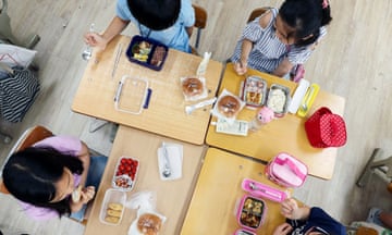South Korean elementary school students eat lunch