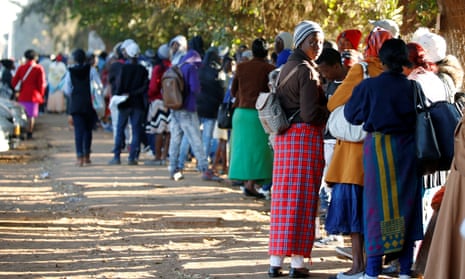Zimbabweans queue outside a Home Affairs Department office to apply for passports in Harare, Zimbabwe, July 3, 2019. REUTERS/Philimon Bulawayo