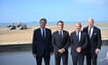 David Cameron, Emmanuel Macron, Olaf Scholz and Joe Biden posing for photographs on Omaha Beach