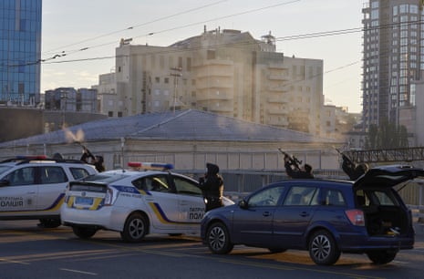 Ukrainian soldiers shoot at a drone that appears in the sky above Kyiv.