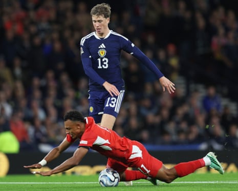 Switzerland's Dan Ndoye falls to the ground in a clash with Scotland's Jack Hendry, leading to a free-kick on the edge of the area and a red card for Hendry.