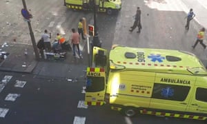 A TV image shows emergency staff and members of the public attending the injured.