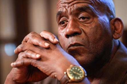 A bald middle-aged man looks pensively.