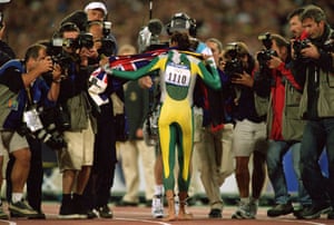 Cathy Freeman surrounded by photographers after in the women’s 400m final.