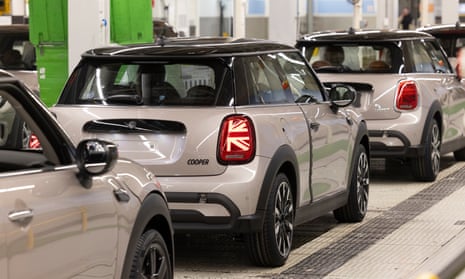 a row of small silver cars in a line
