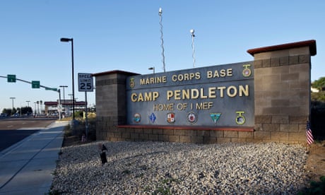 FILE - This Nov. 13, 2013, file photo shows the main gate of Camp Pendleton Marine Base at Camp Pendleton, Calif. Marine Corps prosecutors were scrambling Tuesday, Nov. 19, 2019, to save their numerous cases against Marines accused in a human smuggling and drug investigation after a military judge ruled it was illegal to arrest them during a morning battalion formation. (AP Photo/Lenny Ignelzi, File)