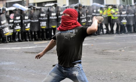 Demonstrators clash with riot police during a protest in Quito against the constitutional amendment allowing indefinite re-election of the president.