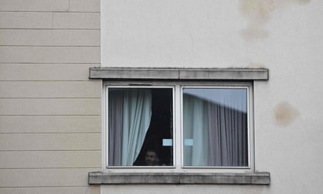A man looking out of a hotel window