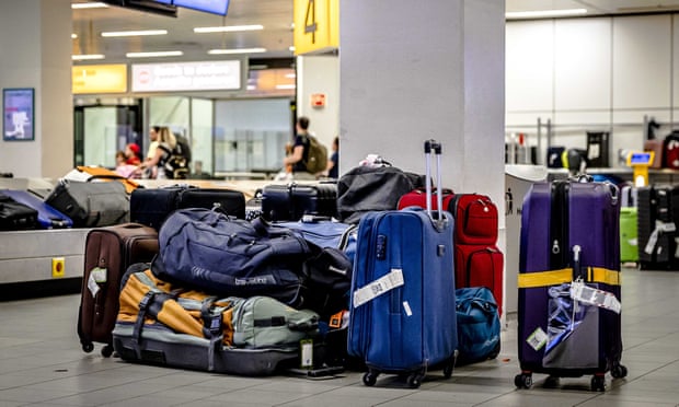 Pile of suitcases near the conveyor belt