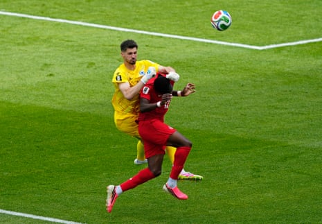 Bosnia and Herzegovina's Nikola Vasilj collides with Canada's Tani Oluwaseyl.