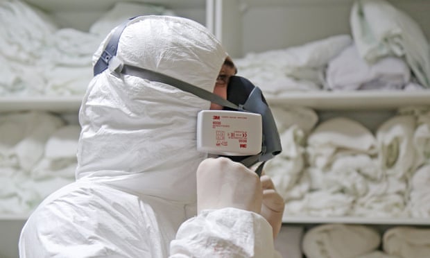 A medical worker puts on protective gear at a hospital in Makhachkala