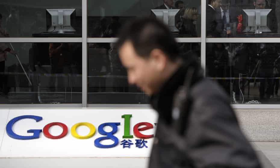 A security guard walks past while foreign visitors are seen inside the Google China headquarters in Beijing.