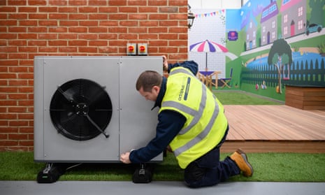 An engineer checks the installation of a Daikin 7KW heat pump on a model house within the Octopus Energy training facility in Slough, England.