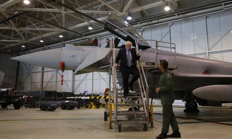 Boris Johnson walking down steps while talking to Group Captain Chris Layden after he viewed a Typhoon fighter jet at RAF Lossiemouth, Moray.