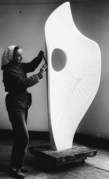 Hepworth works on plaster of a thin, holed sculpture taller than she is
