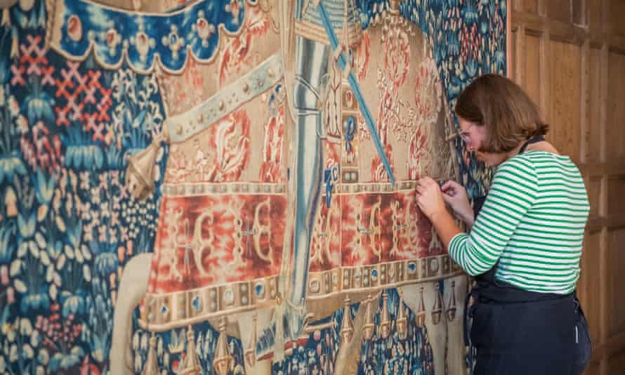 A National Trust conservator checking the tapestry.