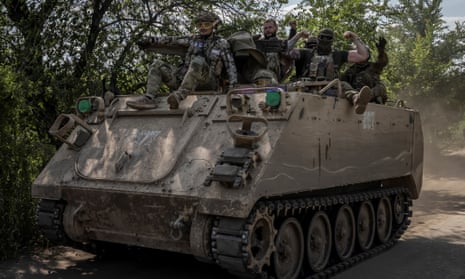 Ukrainian troops ride an M113 armoured personnel carrier near Bakhmut