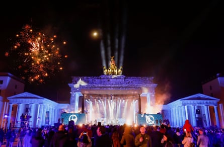 Fireworks explode behind the Brandenburg Gate in Berlin.