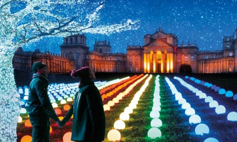 Couple look at illuminated front of Blenheim Palace