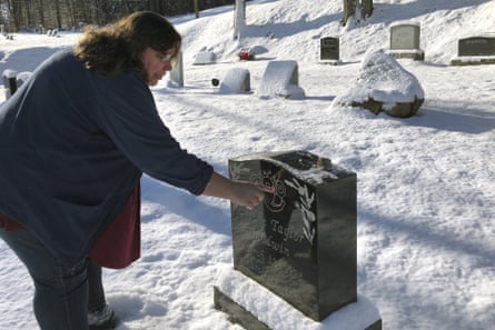 woman next to grave in snow