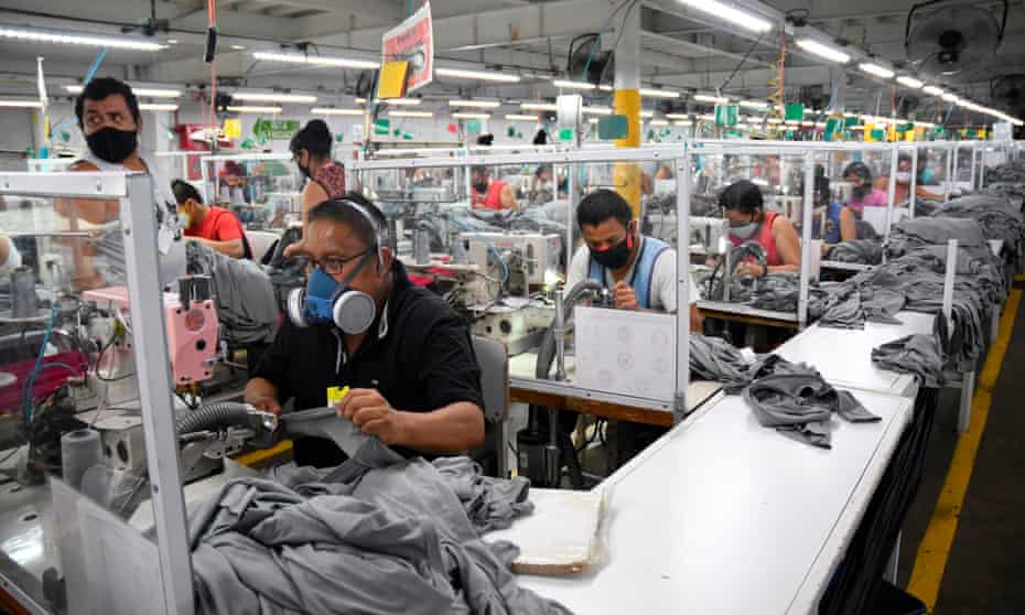 Workers wear face masks as a preventive measure against the spread of the coronavirus at the textile plant KP Textil in San Miguel Petapa, on 10 July.