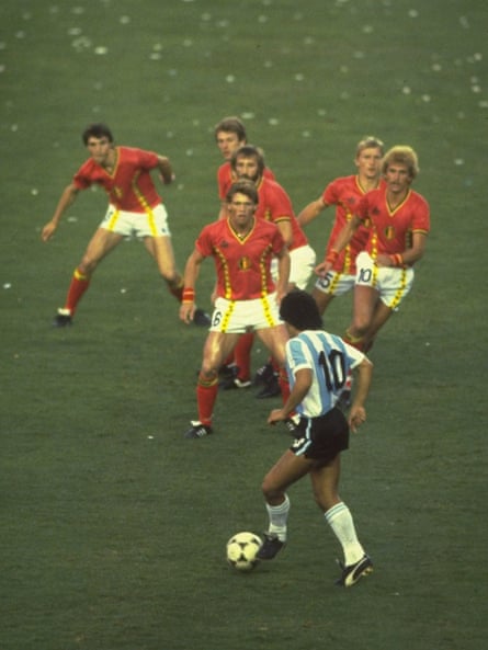 Diego Maradona of Argentina is confronted by a posse of Belgium defenders during a match at the 1982 Wold Cup in Spain
