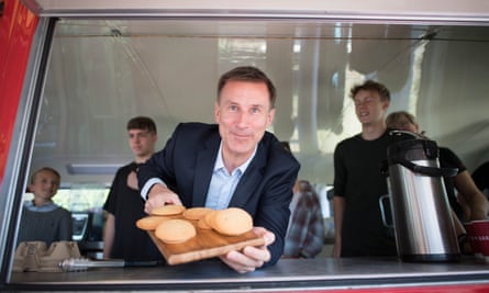 Jeremy Hunt helps to serve refreshments at the Surrey Para Games in Godalming during the Tory leadership race in 2022.