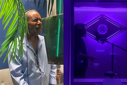 Two men singing into different mics in different rooms.